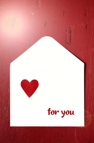 Valentines Day letter envelope on red background. with lens flare. - Photo, Image