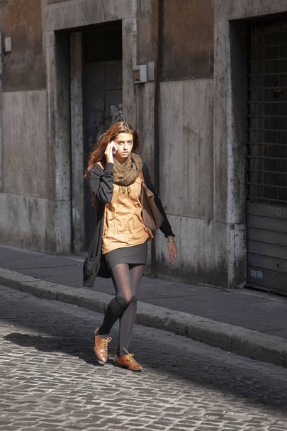 Rome, Italy, October 14, 2011: Young elegant girl walking down the street Genre - Fotoğraf, Görsel