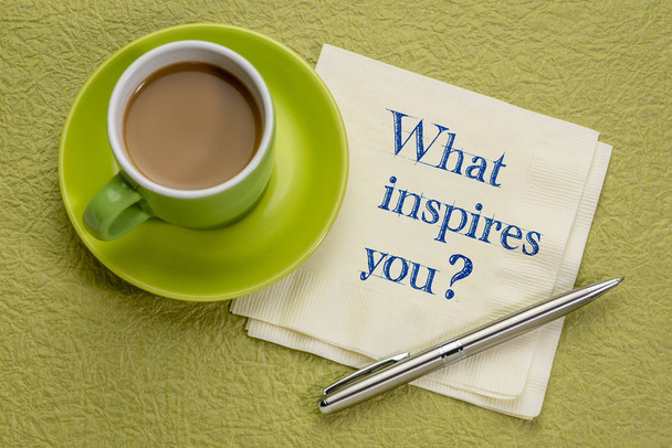 What inspires you? Handwriting on a napkin with a cup of coffee - Фото, зображення