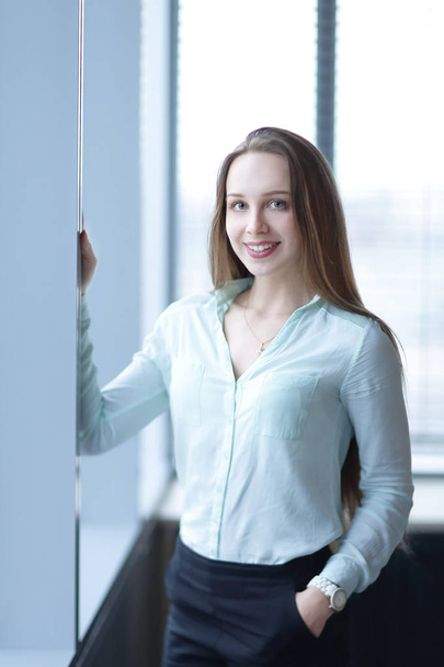 business woman standing near the window in the corridor of the office. - Φωτογραφία, εικόνα