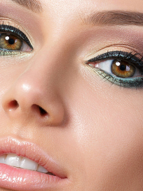 Close up beauty portrait of young woman with beautiful makeup. Studio shot. Extreme closeup, partial face view - Fotoğraf, Görsel