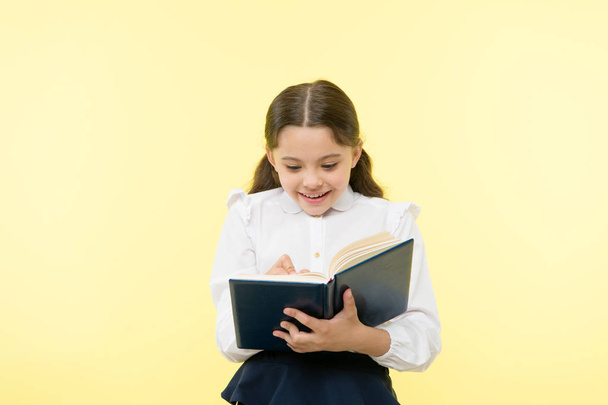 Back to school. Childhood happiness. happy little girl in school uniform. small girl child. private teaching. Smart school girl. childrens day. Education online. She has got the book she needs - Foto, imagen