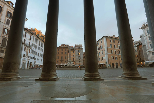 View on square with fountain through Pantheon basilica columns, Rome, Italy - 写真・画像