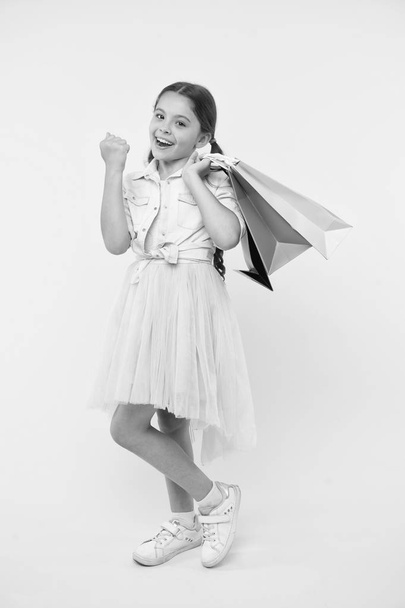 School supplies shopping list. Back to school season great time to teach budgeting basics children. Prepare for school season buy supplies stationery clothes in advance. Girl carries shopping bags - Foto, Imagem