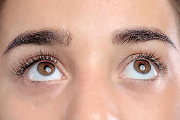 Young woman with beautiful natural eyelashes, closeup view - 写真・画像