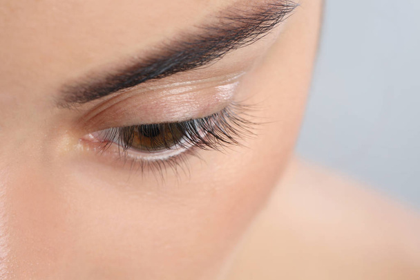 Young woman with beautiful natural eyelashes, closeup view - 写真・画像