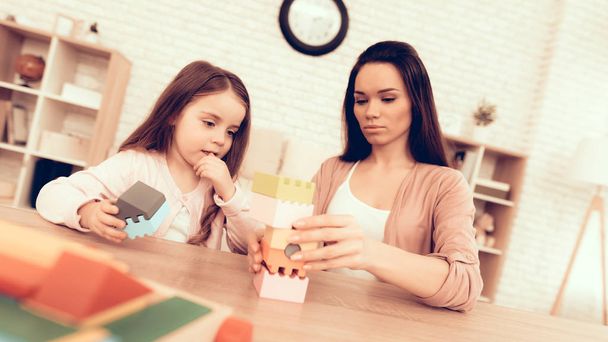 Mother Teaches Daughter. Educational Games. Colors Cubes. Learning Child at Home. Cost House of Cubes. Cubes and Puzzles. Child Development. Board Games for Children. Modern Learning for Children. - Fotografie, Obrázek