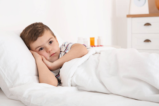 Sick boy lying in bed. Little patient waiting for doctor at home - Φωτογραφία, εικόνα