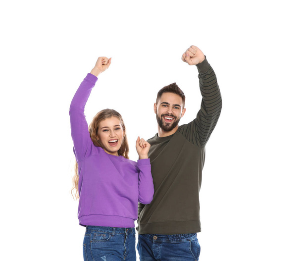 Happy young people celebrating victory on white background - Foto, afbeelding