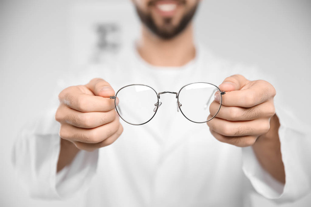 Male ophthalmologist with eyeglasses in clinic, closeup - Foto, Bild