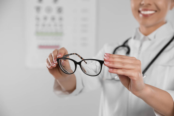 Female ophthalmologist with eyeglasses in clinic, closeup. Space for text - Fotografie, Obrázek