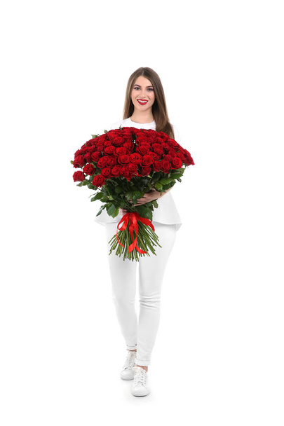 Full length portrait of beautiful woman with bouquet of roses on white background - Фото, изображение