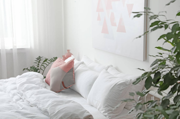 Comfortable bed with soft pillows in room interior - Φωτογραφία, εικόνα