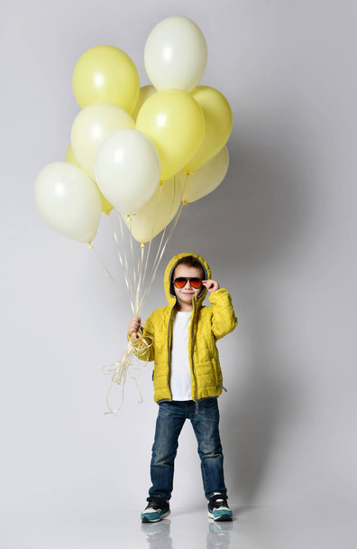 Stylish little boy holding air balloon isolated on white - Foto, afbeelding