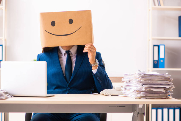 Happy man employee with box instead of his head - Foto, Imagen