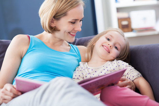Mother and daughter reading together - Photo, Image