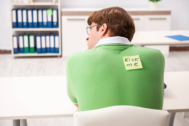 Office prank with kick me message on sticky note - Photo, Image
