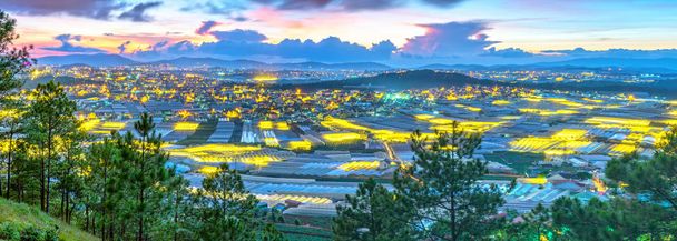 City night scene of a valley in Da Lat with greenhouses to plant flowers and vegetables. Blue hour moments when the sun sets it's time to light valley beauties adorn the romantic highland Vietnam - Photo, Image