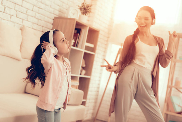 Girl and Smiling Woman in Pajamas Dancing at Home. - Foto, afbeelding