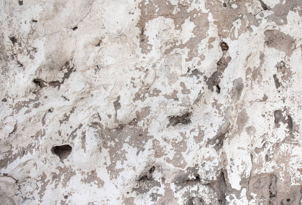 Крупный план бежевой пористой каменной текстурированной стены
 - Фото, изображение