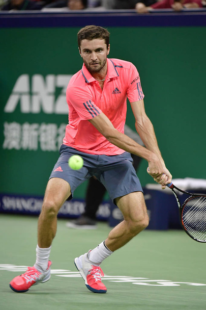 Gilles Simon of France returns a shot to Stan Wawrinka of Switzerland in their men's singles third round match during the 2016 Shanghai Rolex Masters tennis tournament in Shanghai, China, 13 Octobter 2016 - Photo, Image
