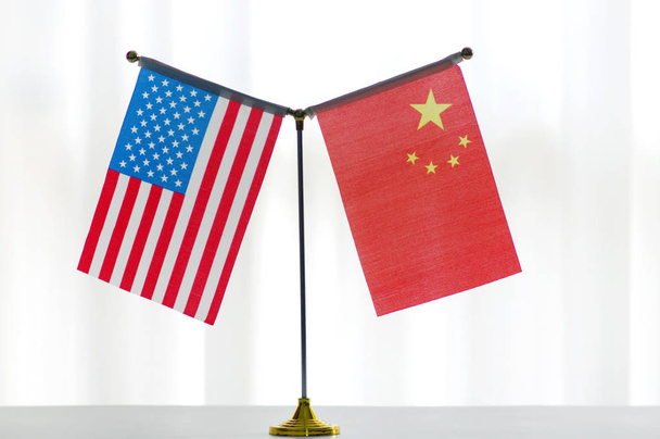 National flags of China and the United States are seen in Ji'nan city, east China's Shandong province, 14 June 2018. - Photo, Image