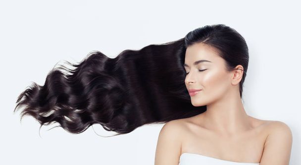 Relaxing spa woman with blowing curly hair on white. Relaxation, haircare and wellness concept - Φωτογραφία, εικόνα