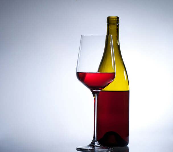 Glass of red wine and a bottle - Fotografie, Obrázek