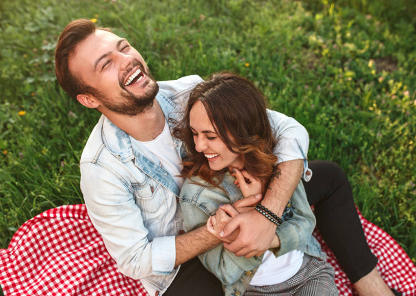 Young man hugging girlfriend and laughing in countryside - Foto, Bild