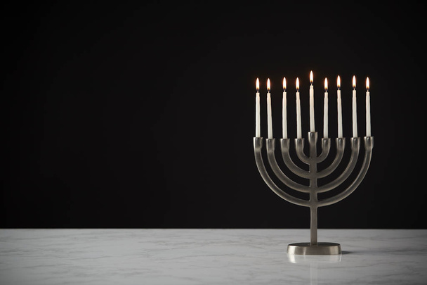 Hanukkah Menorah With Candles Against Black Studio Background - Фото, зображення
