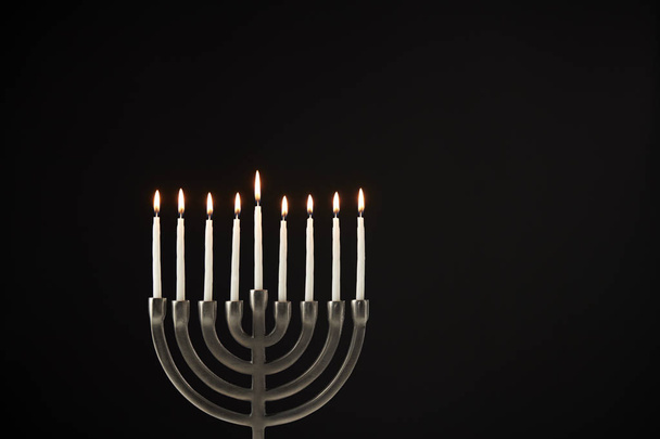 Hanukkah Menorah With burning Candles Against Black Studio Background - Valokuva, kuva