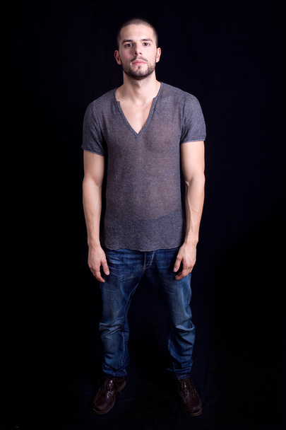 Young casual man full body on a black background - Photo, Image
