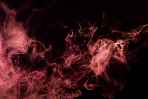 Thick yellow and red smoke on a black isolated background. Background from the smoke of vap - Photo, Image