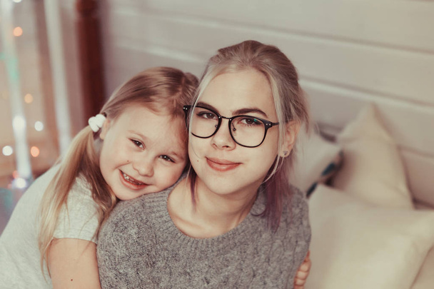 cozy photo session of two beautiful happy sisters in wooden house in style of hyuggi - Valokuva, kuva