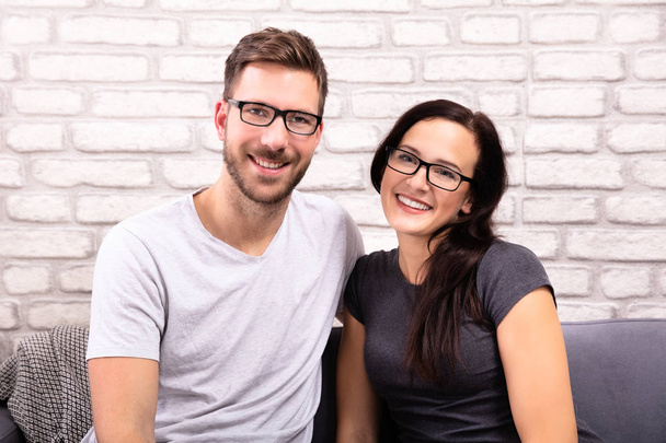 Portrait Of A Happy Young Couple Wearing Eyeglasses - Foto, afbeelding