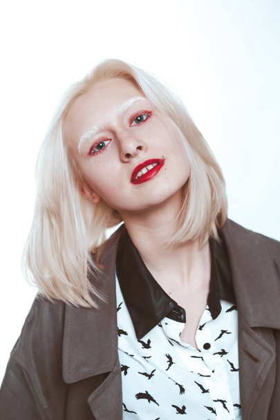 portrait of an albino girl in a raincoat in the studio. - Foto, Imagem