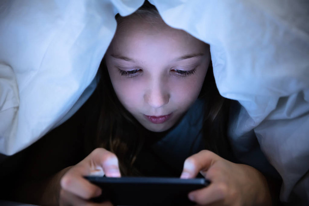 Girl Under White Blanket Using Digital Tablet - Photo, Image