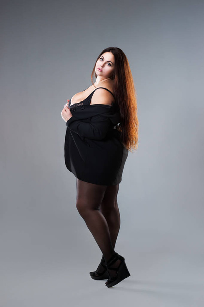Plus size fashion model in sexy clothes, fat woman on gray studio background, overweight female body, full length portrait - Фото, зображення