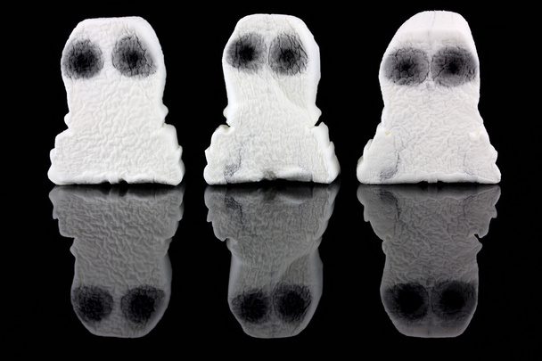 Three white ghosts on a black background - Photo, Image