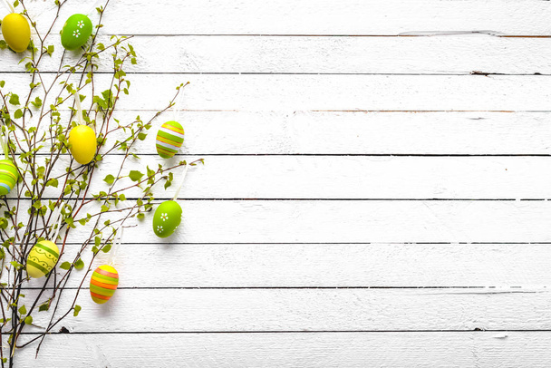 Happy easter egg with pattern. Colored eggs on white wooden background. - Photo, image