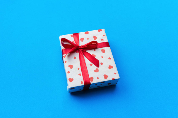 Background with gift box and hearts on blue Background. Top view with copy space for text. - Photo, Image