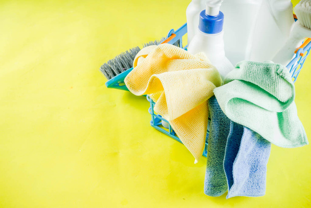 Cleaning concept with different cleaning supplies, on bright yellow background top view, copy space - Photo, Image