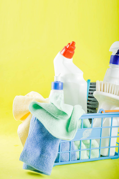 Cleaning concept with different cleaning supplies, on bright yellow background top view, copy space - Photo, Image