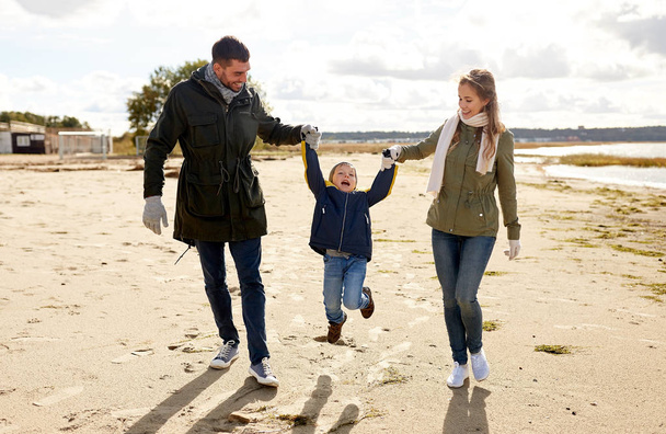 happy family walking along autumn beach - Фото, зображення