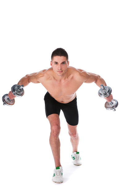athletic guy , execute exercise with dumbbells - Zdjęcie, obraz
