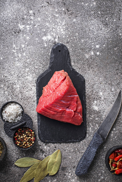 Raw meat on cutting board with spices - 写真・画像
