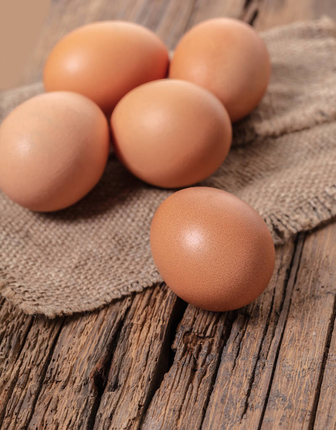 brown chicken eggs close-up on wooden background - 写真・画像