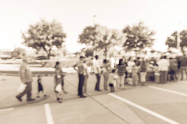 Filtered image blurry background long line of people waiting for - Photo, Image