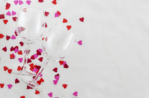 Festive background for Valentines day, couple of glasses, white background with hearts, top view - Фото, зображення