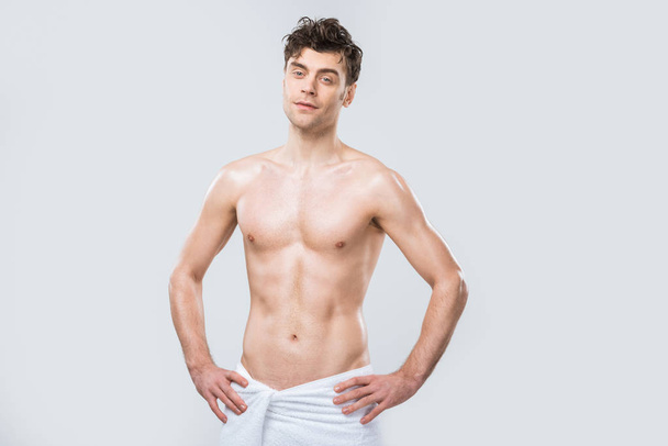 Slim muscular man posing with towel on hips Stock Photo
